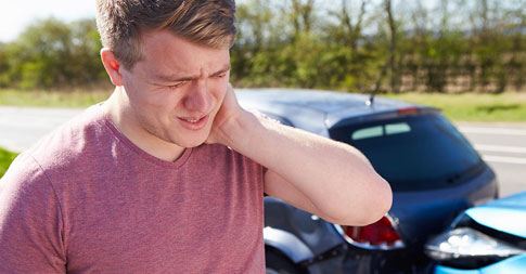young male suffers from neck pain after automobile accident